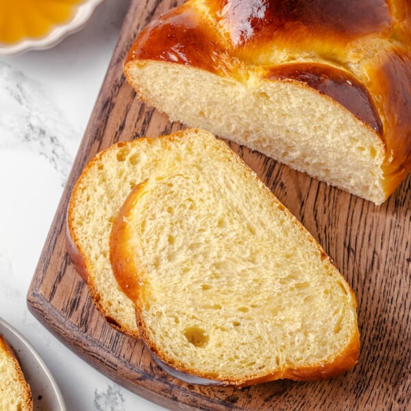 challah slice reveals chewy texture and tight, shiny crumb inside.