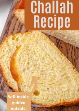 Homemade challah recipe shown sliced to display its fluffy interior and well-browned outer crust.