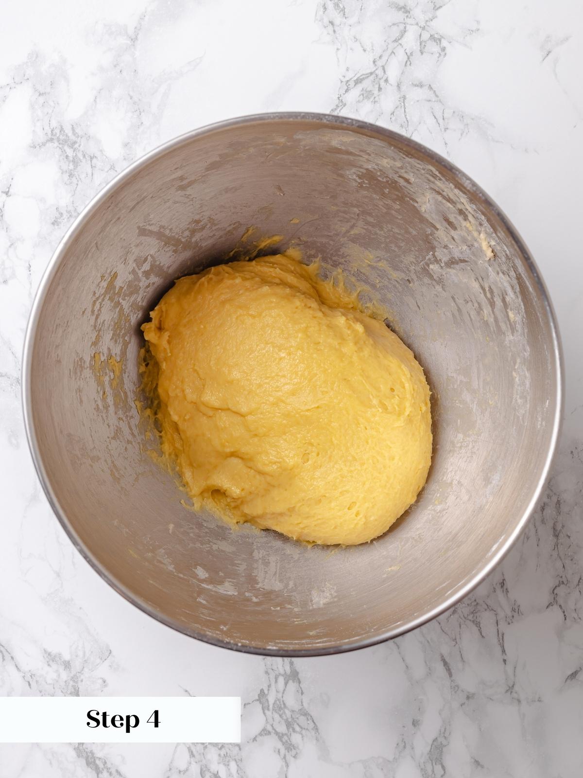 Challah dough in silver mixing bowl before proofing.