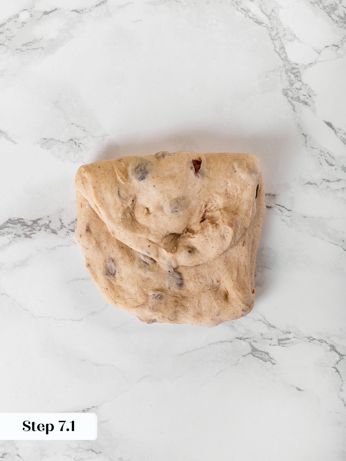 First envelope fold started on cinnamon dough to develop structure.