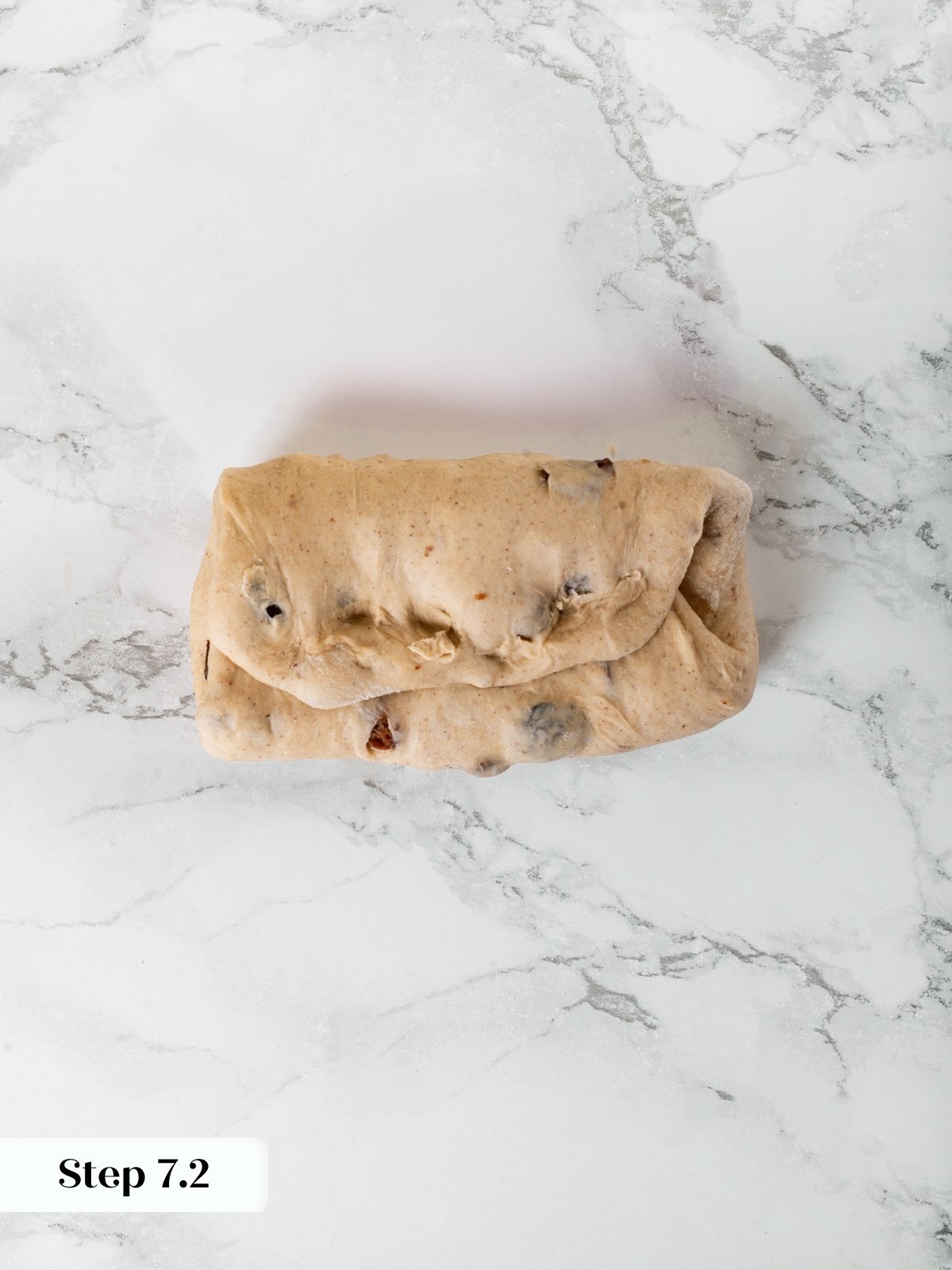 Second fold of envelope technique shown mid-way on rectangular dough for structure.