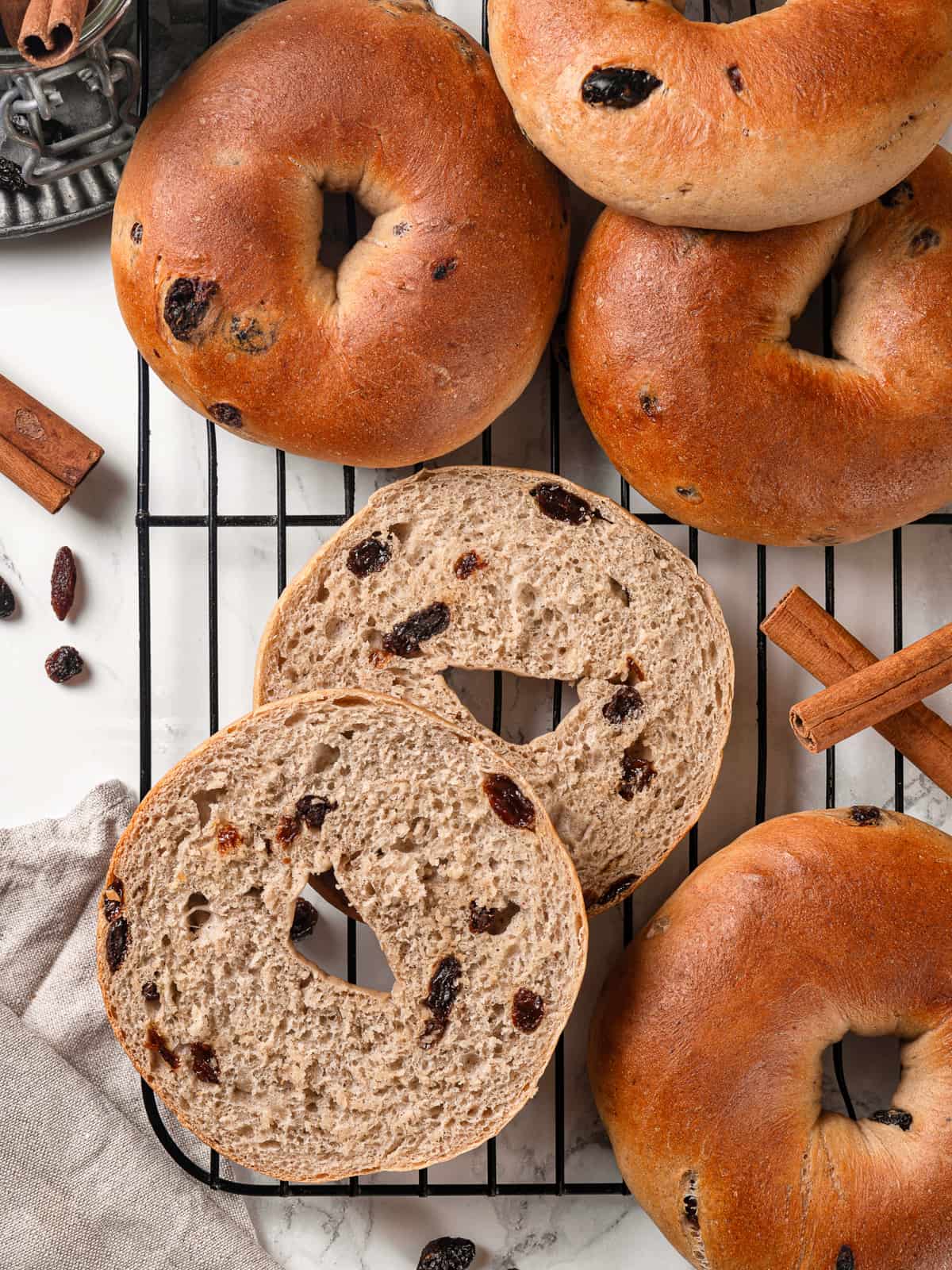 Interior of a bagel revealing a tender crumb and baked raisins throughout the dough.