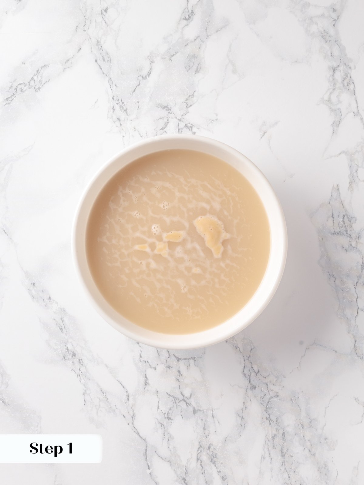 Instant yeast blooming in warm water, starting the French bread dough process from scratch.