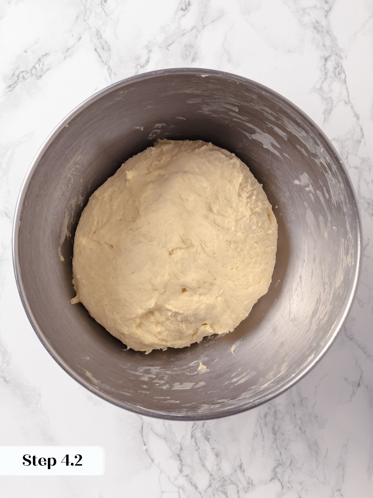 Butter fully mixed into the dough, leaving a soft, shaggy texture ready to smooth with time.