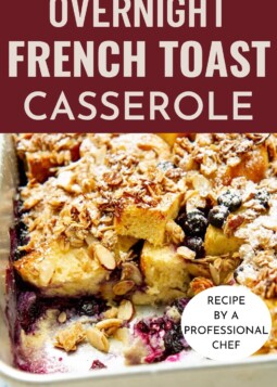 Baked French toast casserole in a silver pan with visible texture and layers of custard-soaked bread.