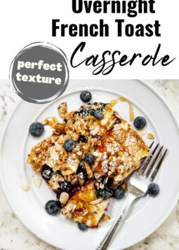 A serving of baked casserole showing fluffy interior and juicy fruit.