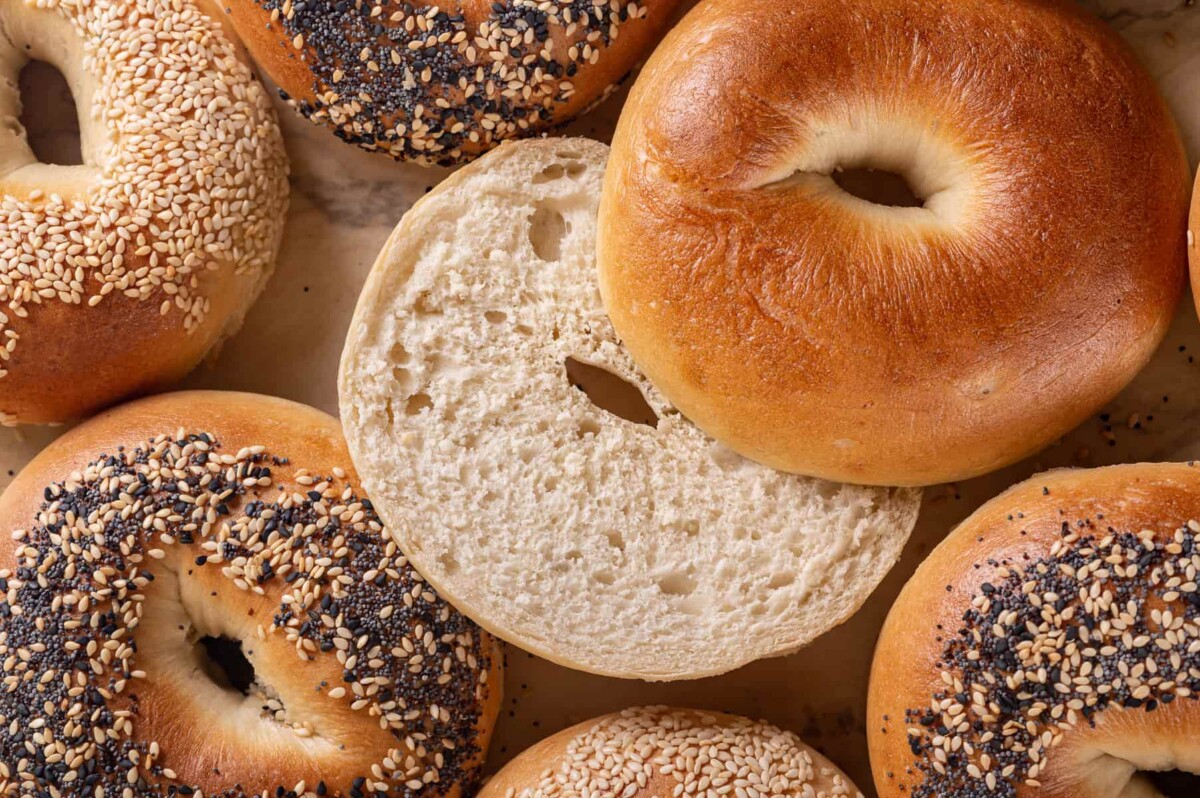Inside of a sliced bagel shows soft texture that came from proper kneading and proofing.