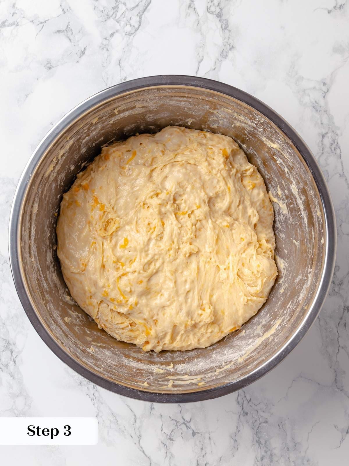 Proofed dough after first rise, showing light texture and readiness for shaping.