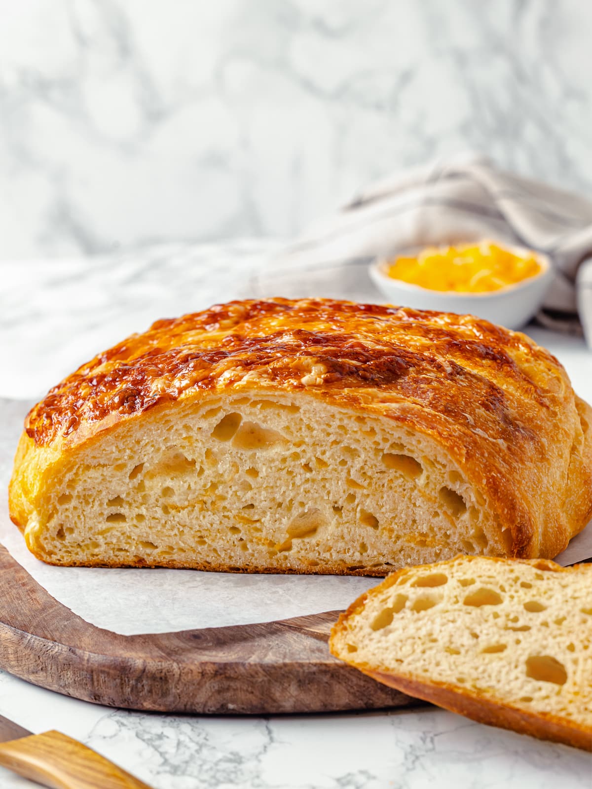 Inside view of sliced bread showing gooey cheese threads and soft, tender interior.