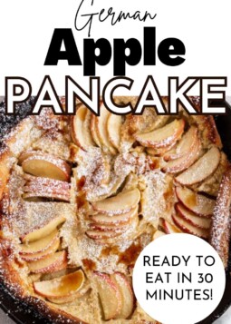 A golden, puffy German apple pancake with thinly sliced apples and topped with powdered sugar, shown in a skillet.