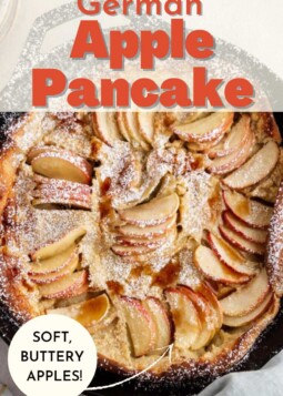A golden, puffy German apple pancake with thinly sliced apples and topped with powdered sugar, shown in a skillet.