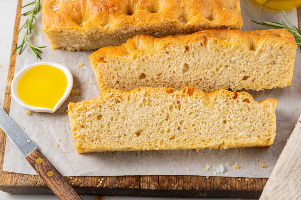 Focaccia slices next to olive oil.