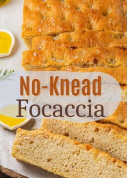 Golden-baked focaccia loaf with deep dimples and a glossy olive oil finish sliced.