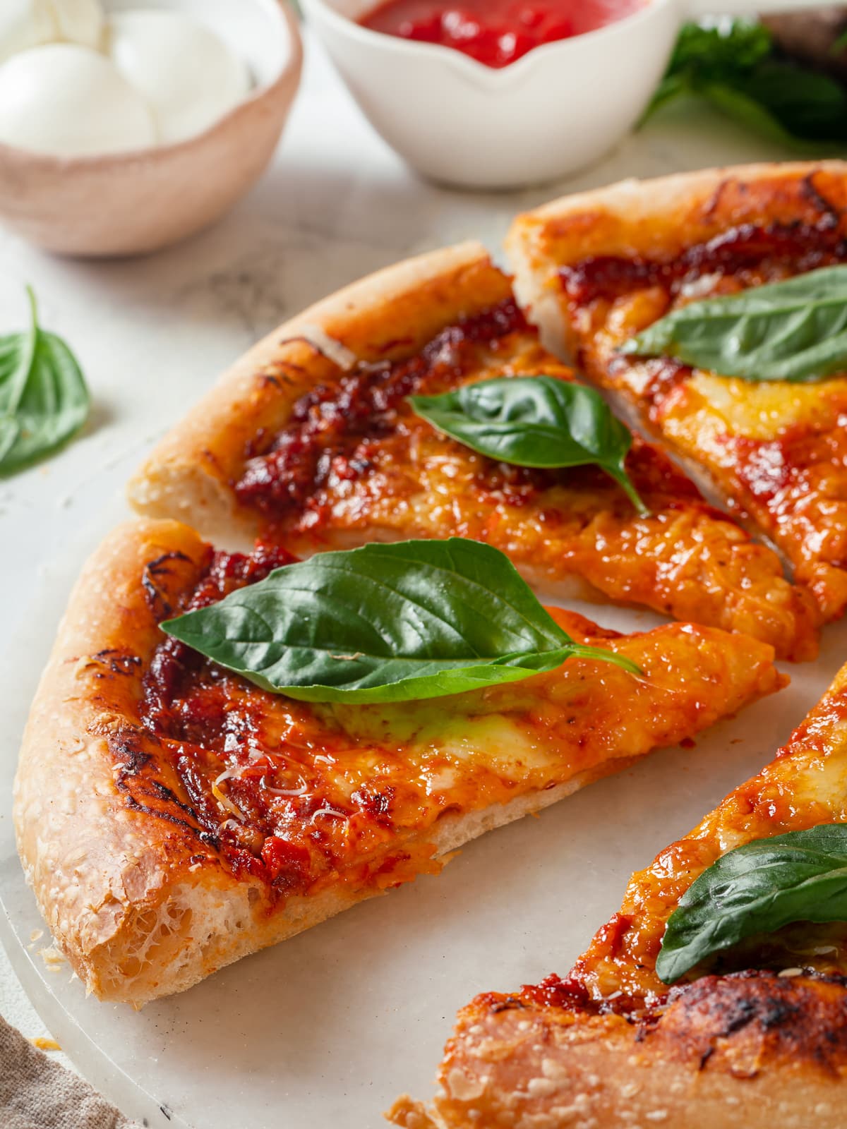 Baked sourdough discard pizza slices highlighting chewy flavorful crust.
