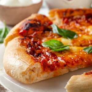 Crispy bottom crust of sourdough discard pizza baked perfectly in oven.