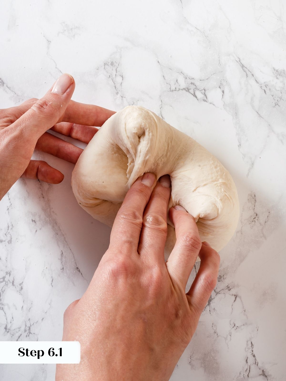 Hands folding sourdough discard dough to strengthen gluten before shaping pizza crust.