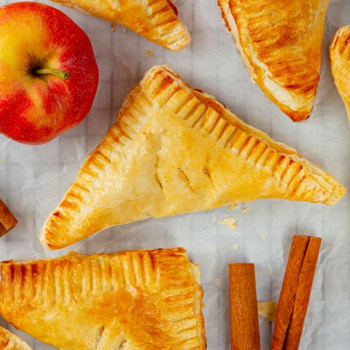 Crisp golden edges of puff pastry turnovers glistening after baking.