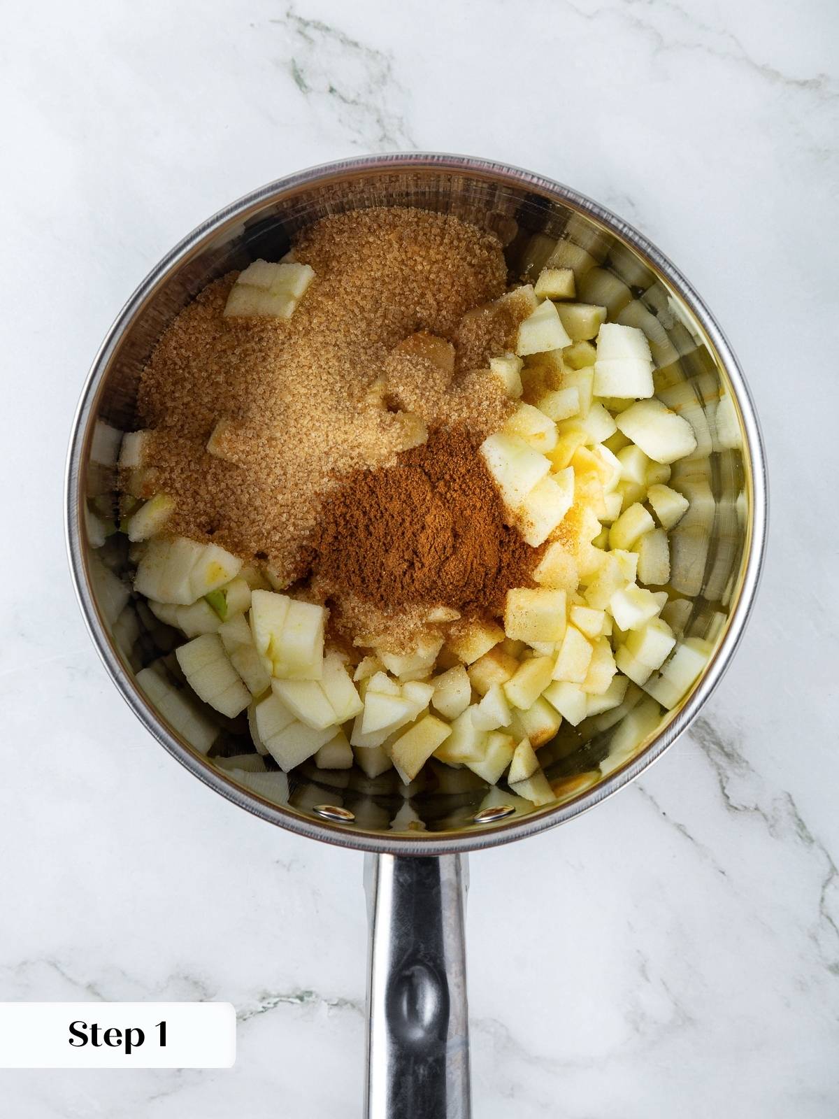 Apple chunks coated in sugar and spices, creating filling for puff pastry turnovers.