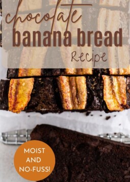 A warm loaf of chocolate banana bread on a countertop, sliced into thick generous pieces.