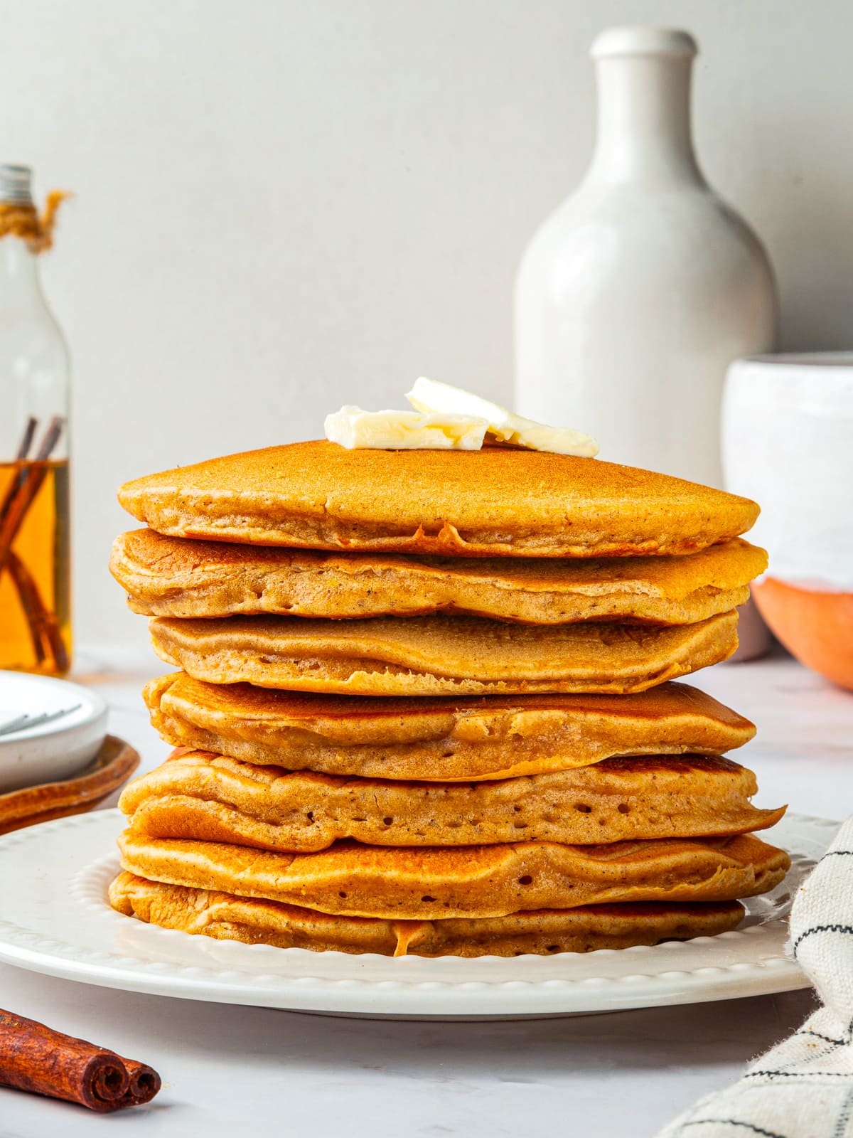 Stack of plain pumpkin pancakes without syrup, showing fluffy texture and golden brown surface.