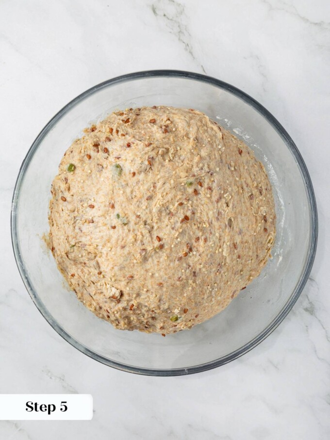 Dough rising in mixing bowl, doubled in size with airy texture.
