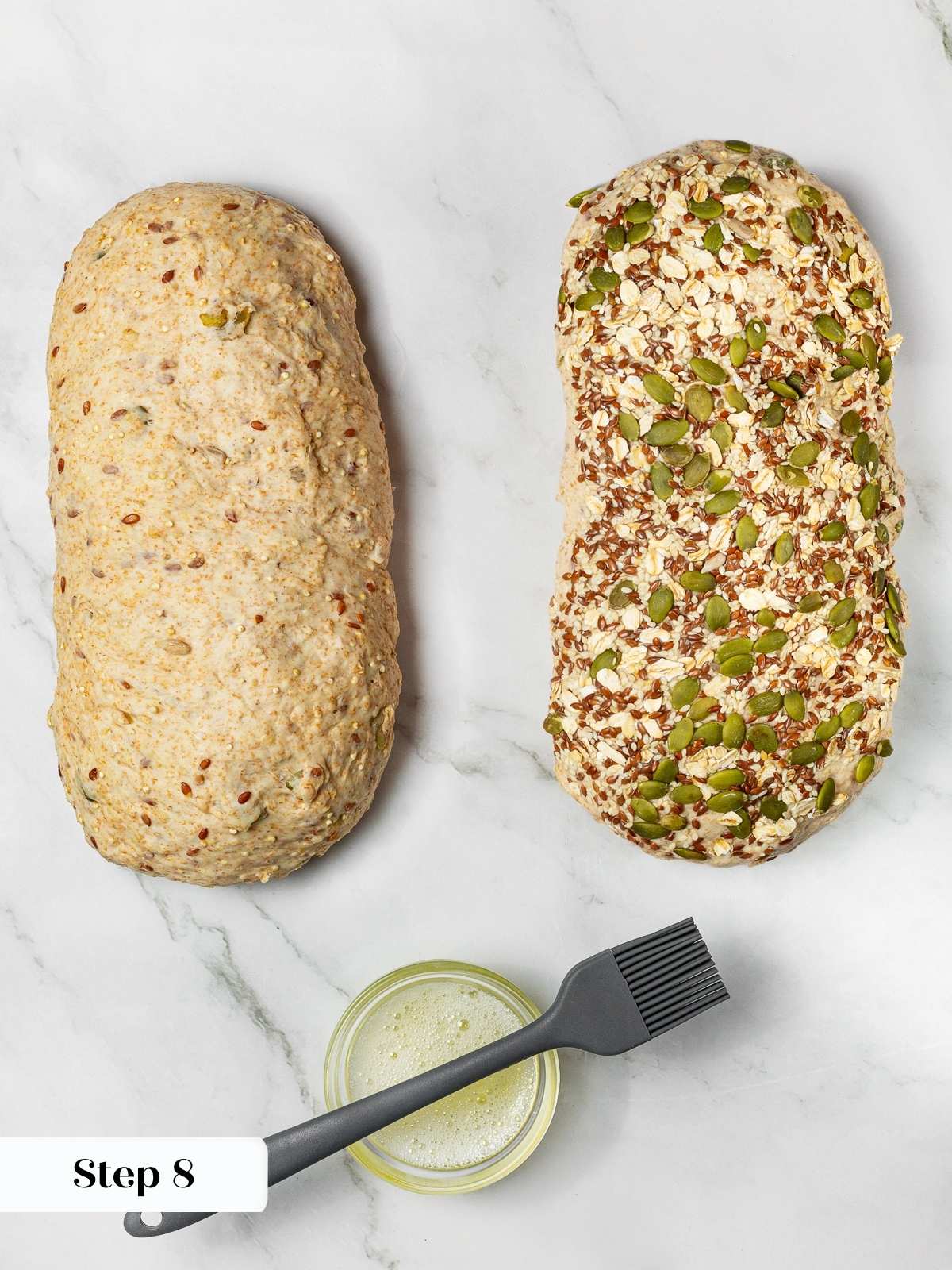 Adding topping of oats and seeds onto dough during bread preparation.