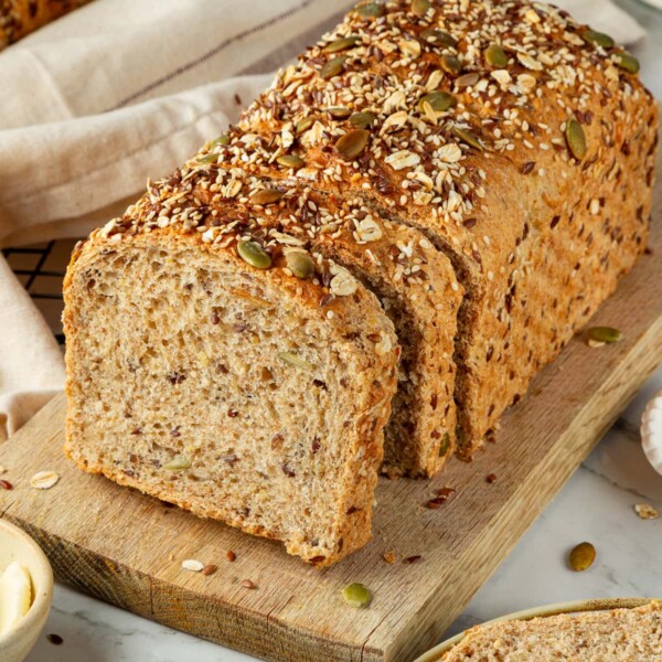 Seeded bread highlighting soft crumb texture with golden crust outside.
