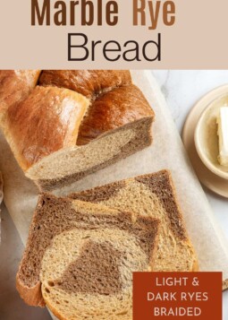 Sliced marble rye loaf revealing soft, tender crumb with cocoa-colored and light rye patterns inside.