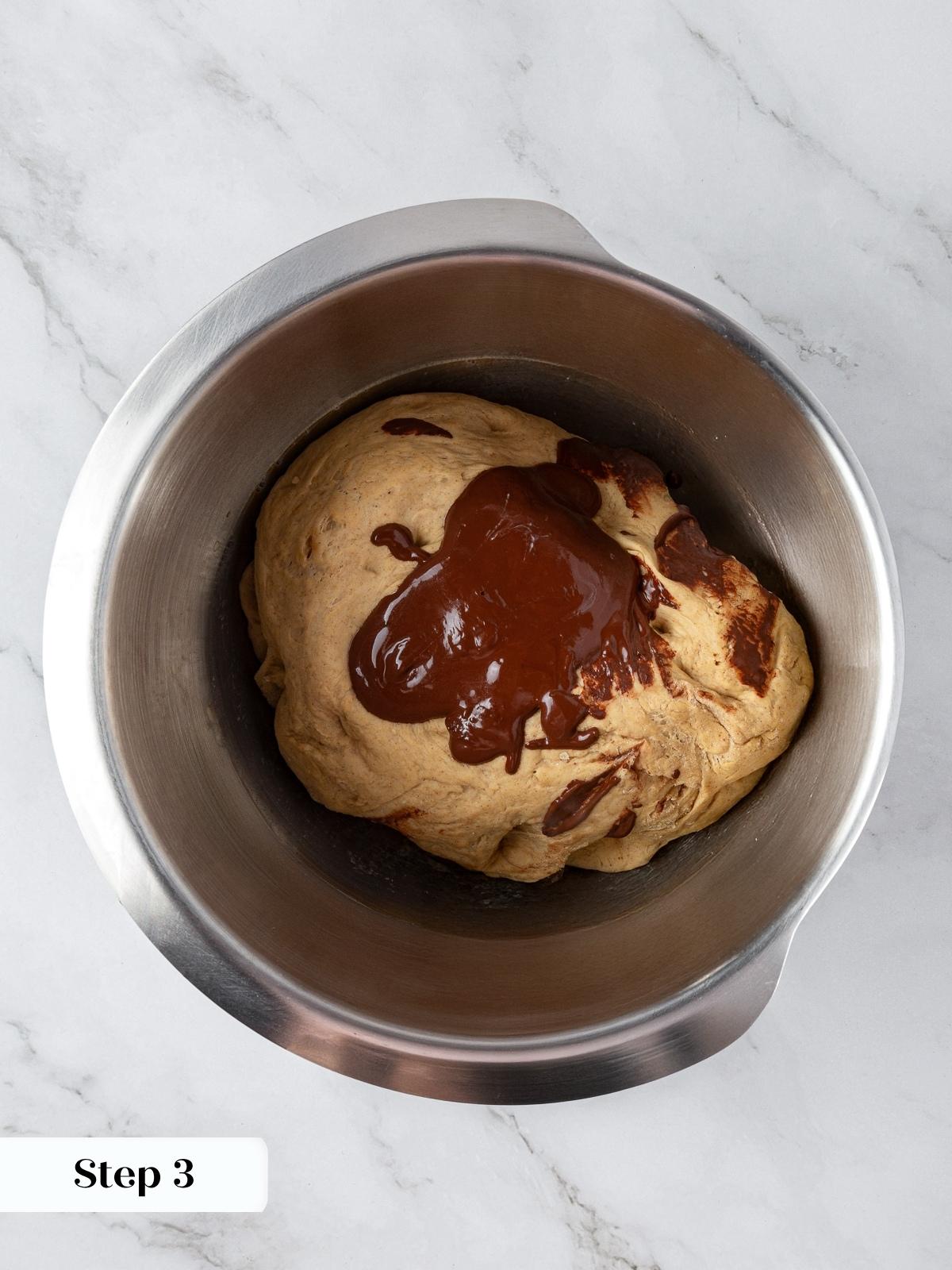 Cocoa mixture being added to half of the rye dough to create dark marbling.