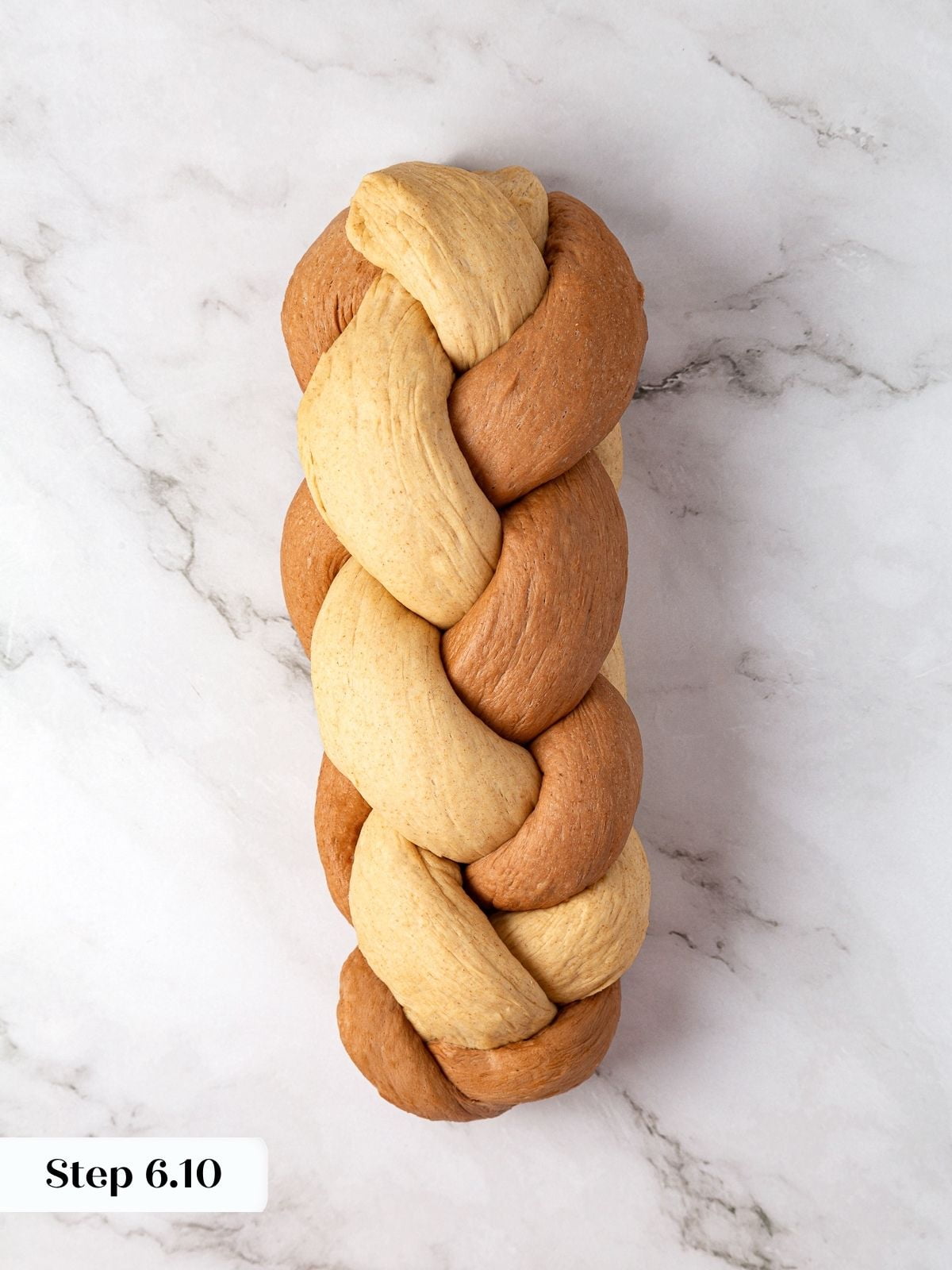 Nearly finished braid of marble rye showing tight woven strands before placing in loaf pan.