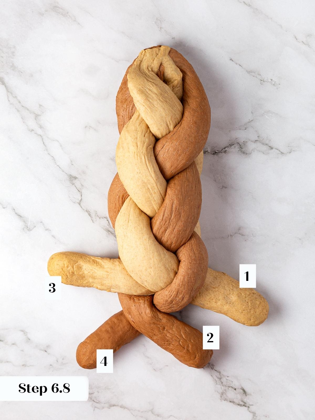 Loaf most of the way braided with four strands of rye dough forming the marbled design.