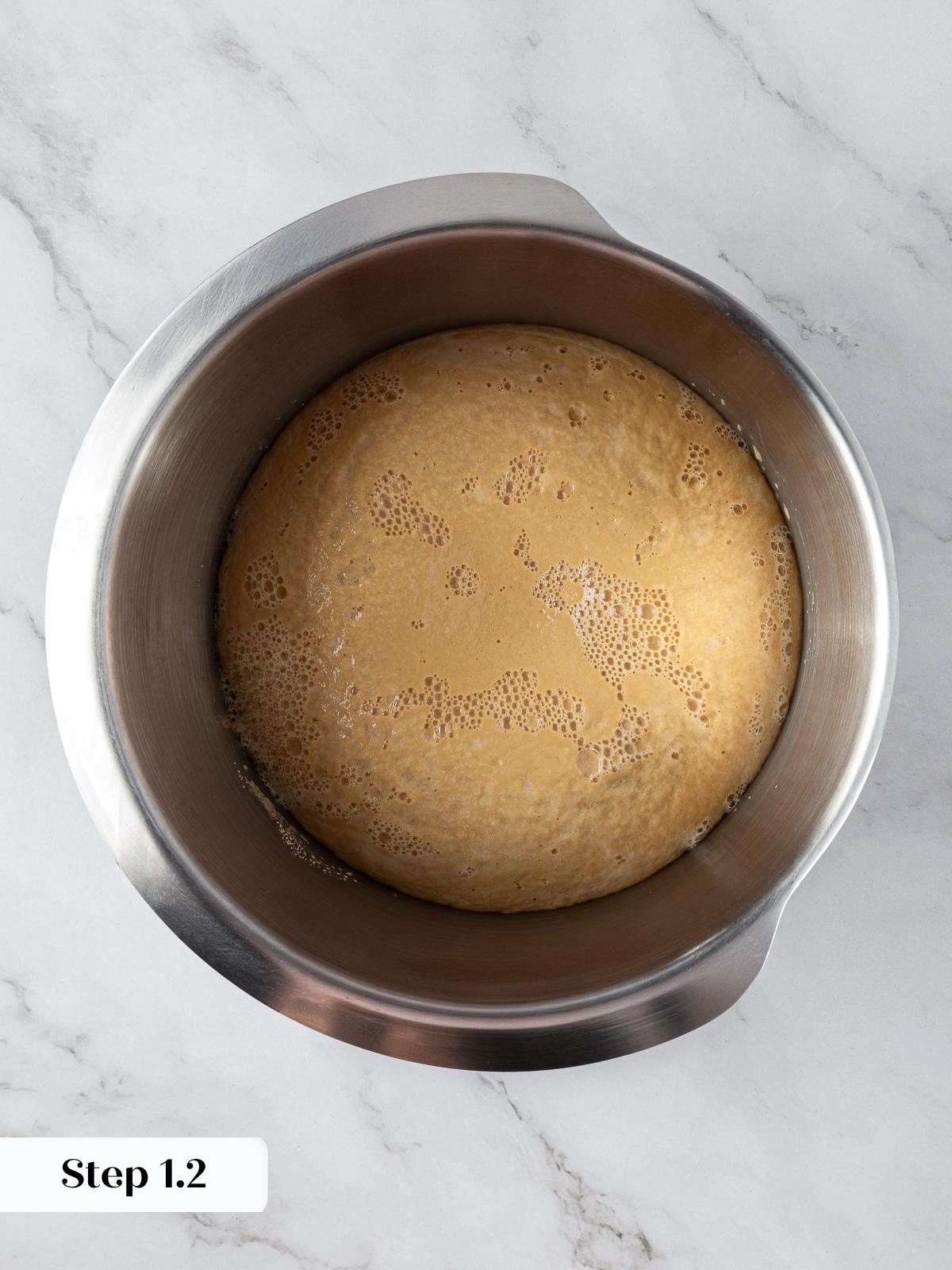 Bowl of yeast mixture beginning to foam before adding flour for marble rye dough.