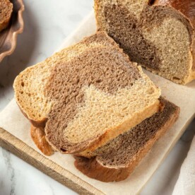 A pair of marble rye slices revealing soft texture and distinct cocoa marbling pattern.