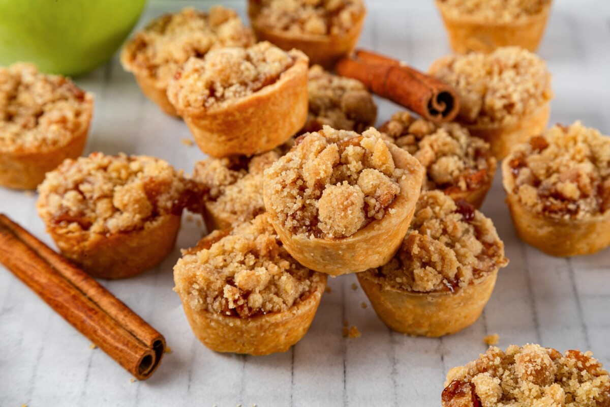 A group of golden brown mini apple pies arranged together for sharing.