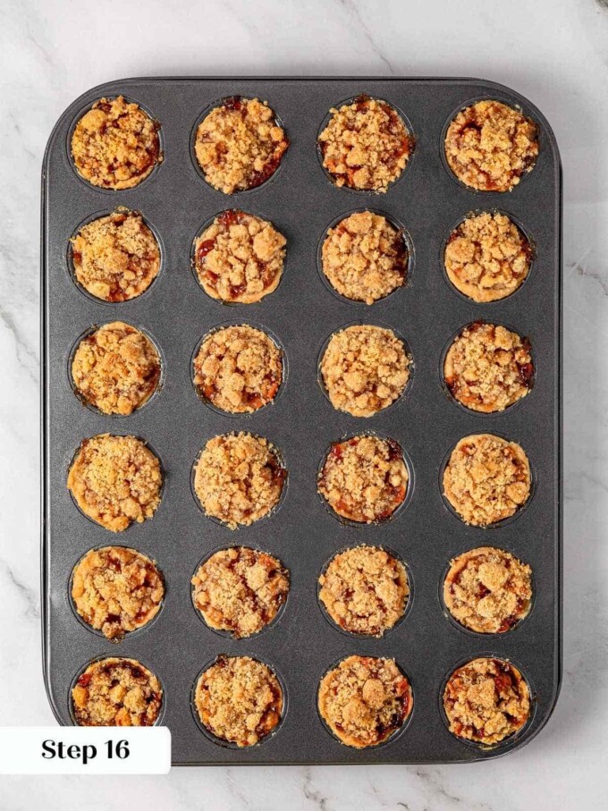 Mini apple pies fully baked and golden in muffin tin with bubbling filling.