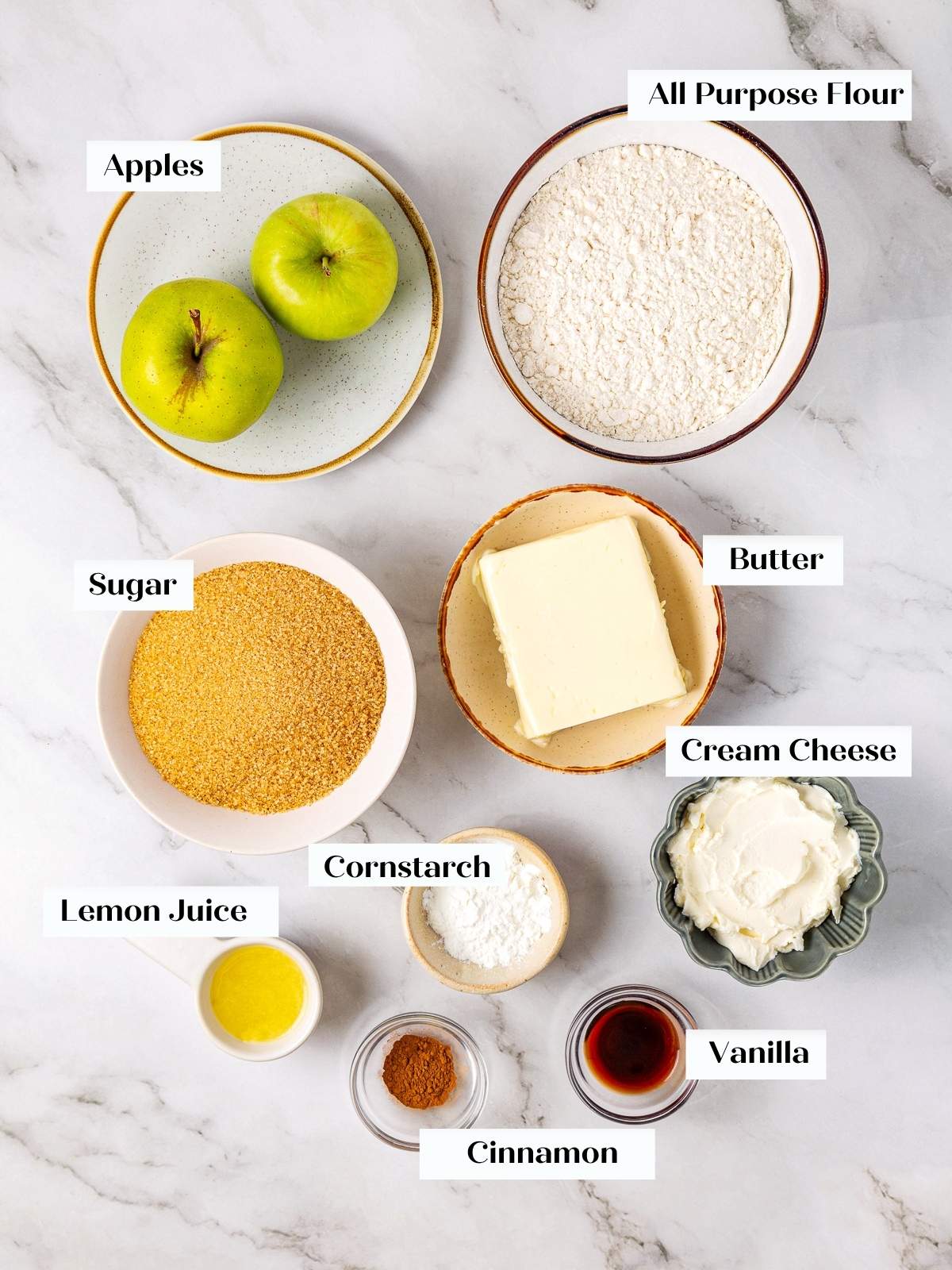 Measured ingredients for mini apple pies arranged on a countertop, ready for baking.