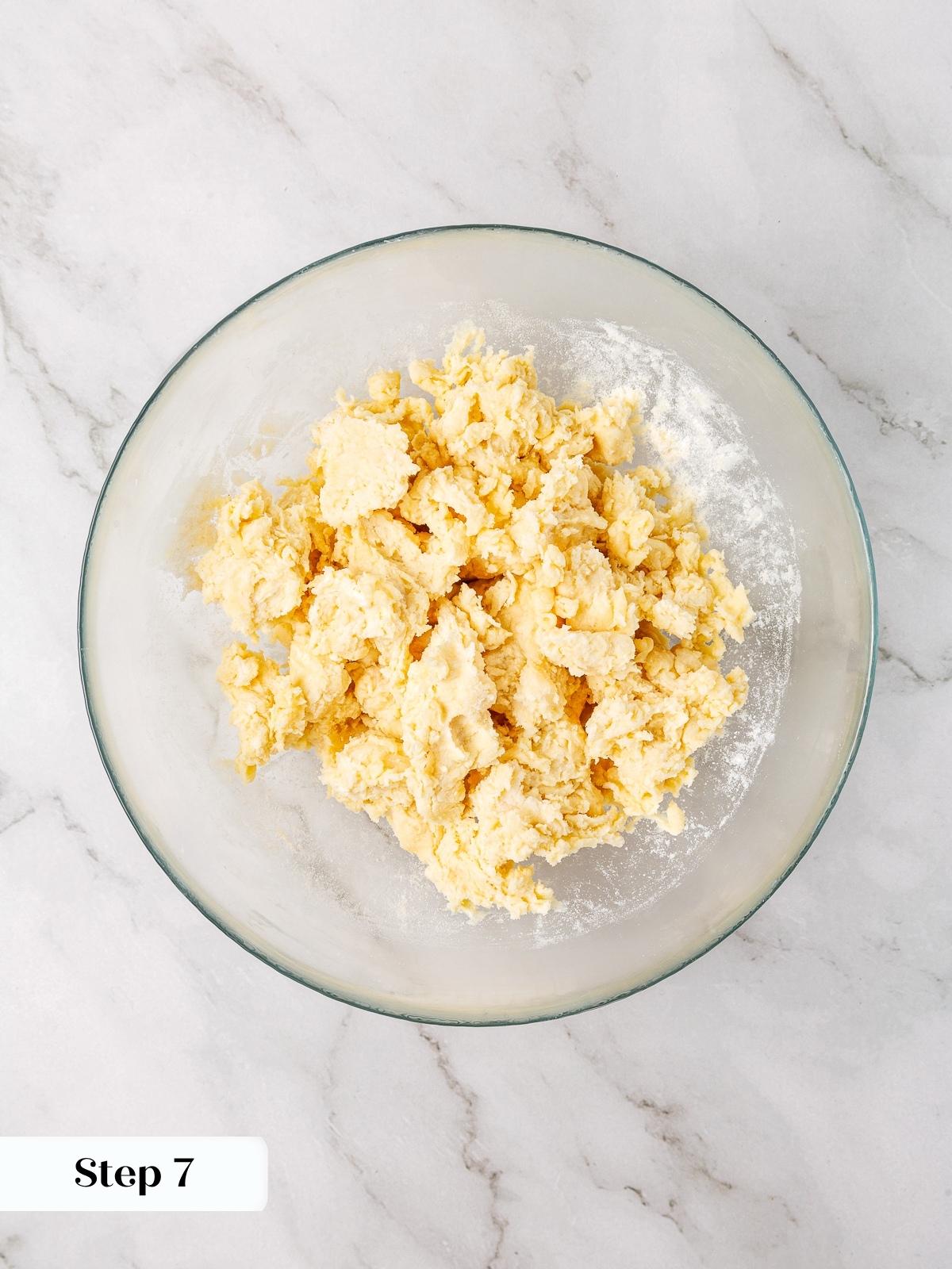 Mixing flour, butter, and cream cheese together in a bowl for mini apple pie crust.