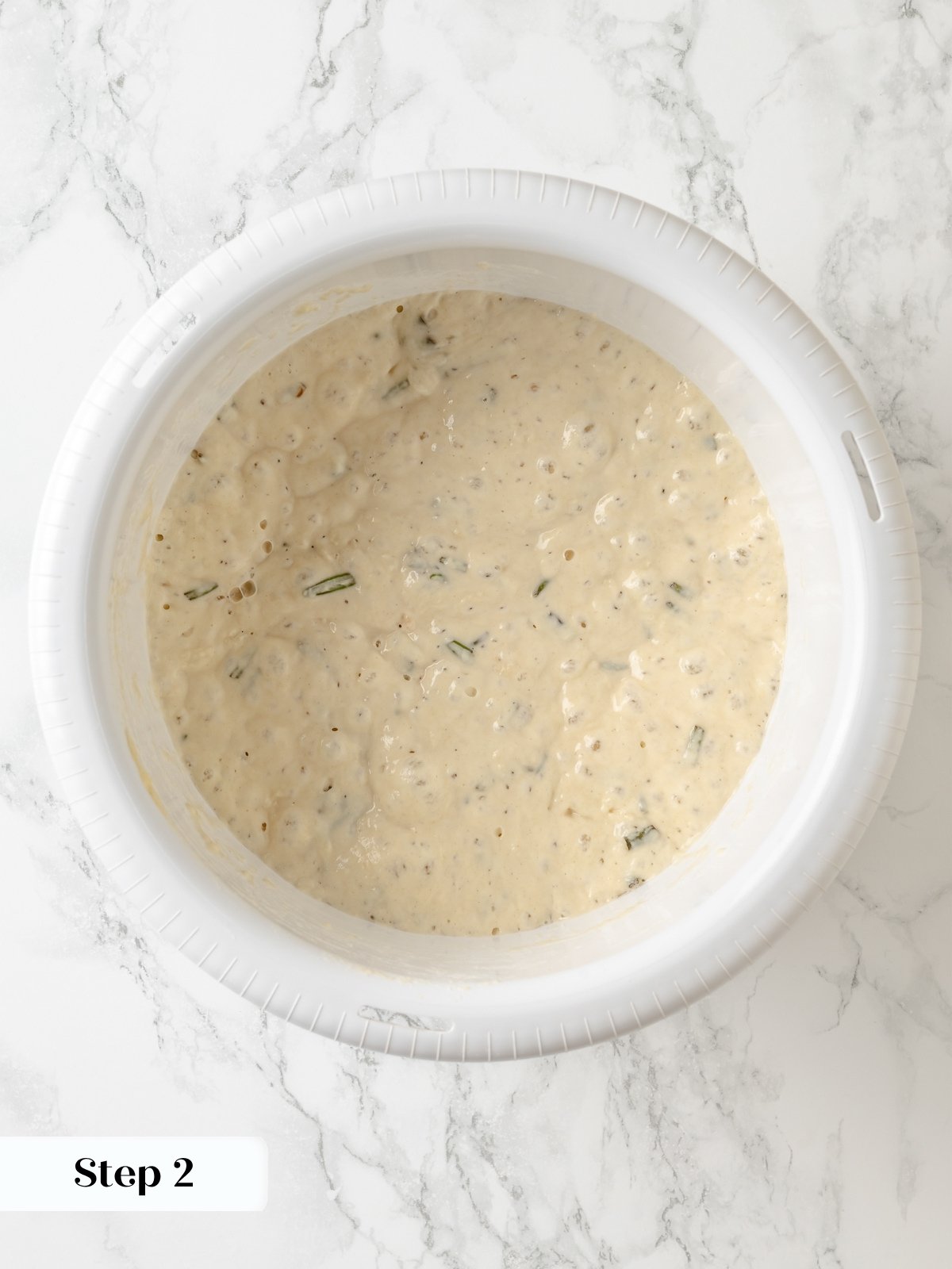 Dough for rosemary bread after overnight proof, bubbly and ready to shape for baking.