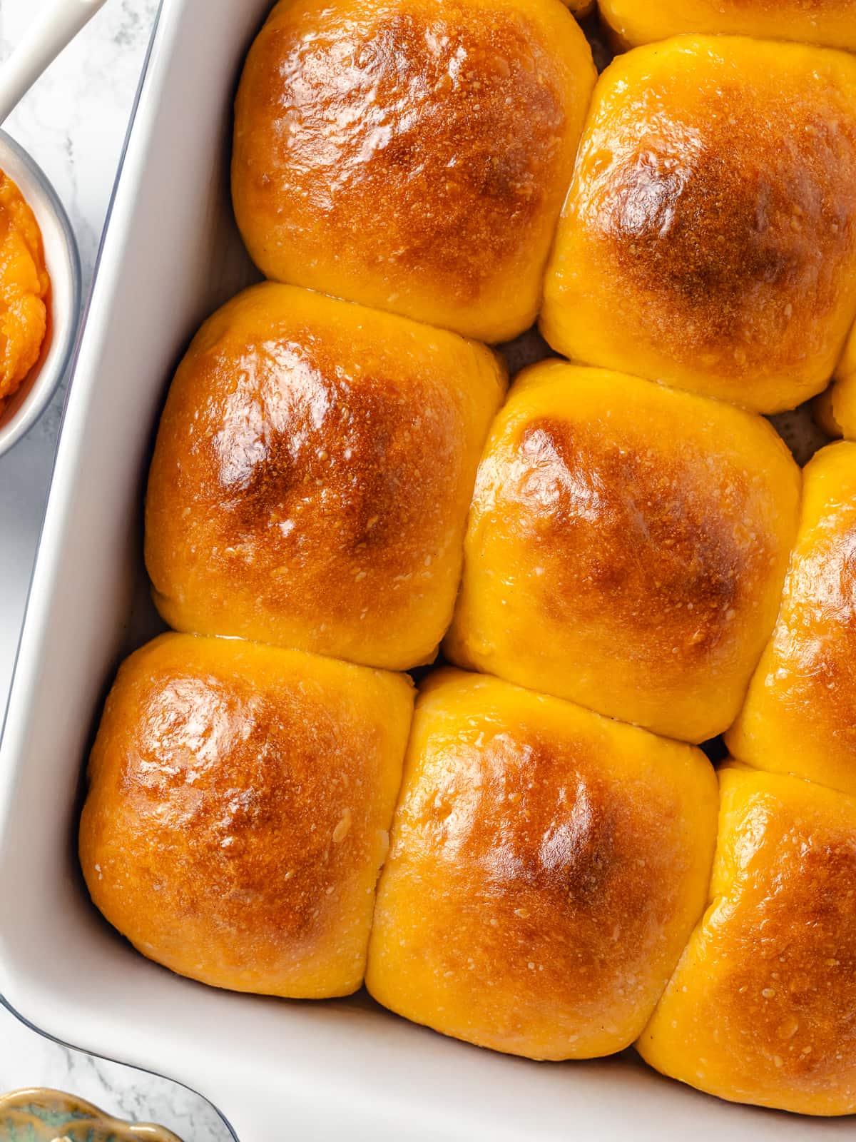 Freshly baked sweet potato rolls brushed with warm brown butter for a nutty finish.