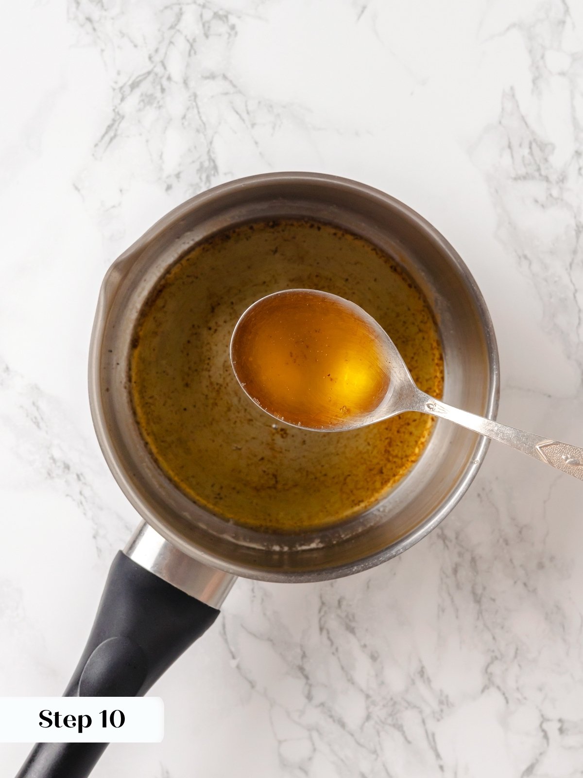 Melted butter in a small pot turning golden brown for brushing sweet potato rolls.