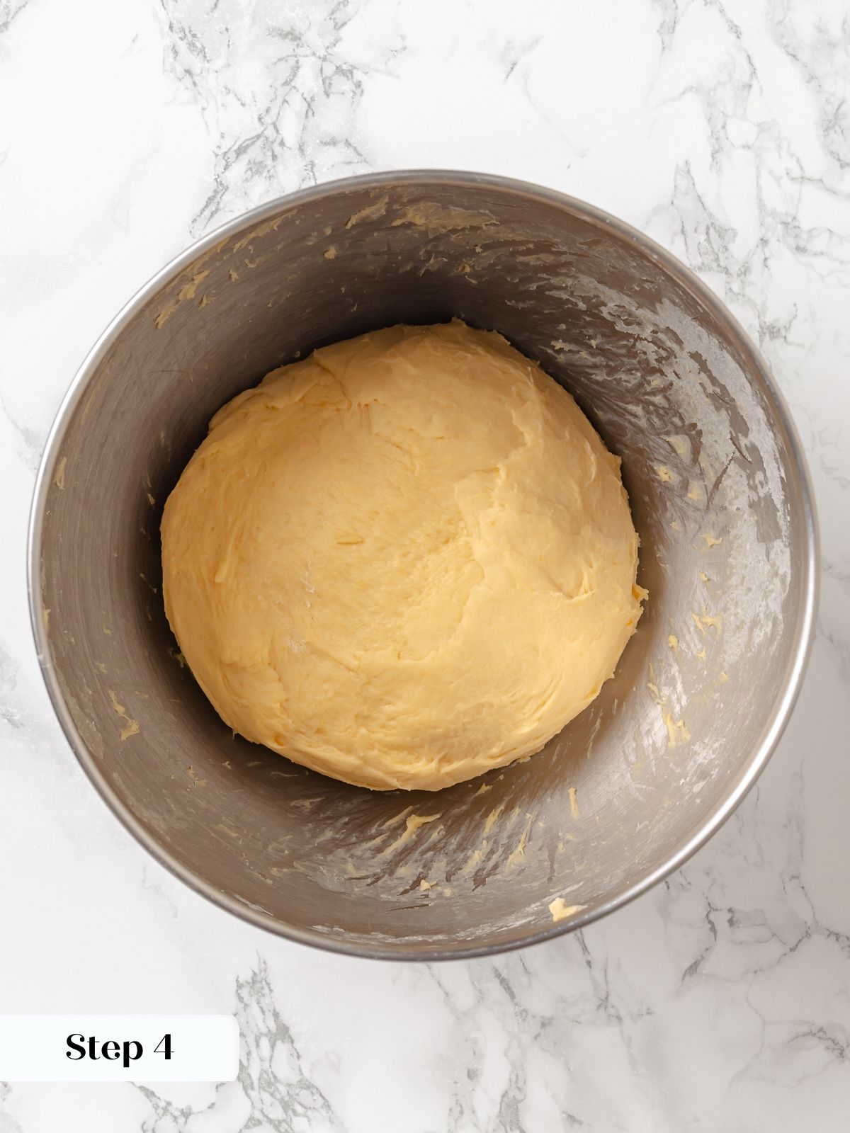 A ball of sweet potato dough showing soft texture and ready for first rise.