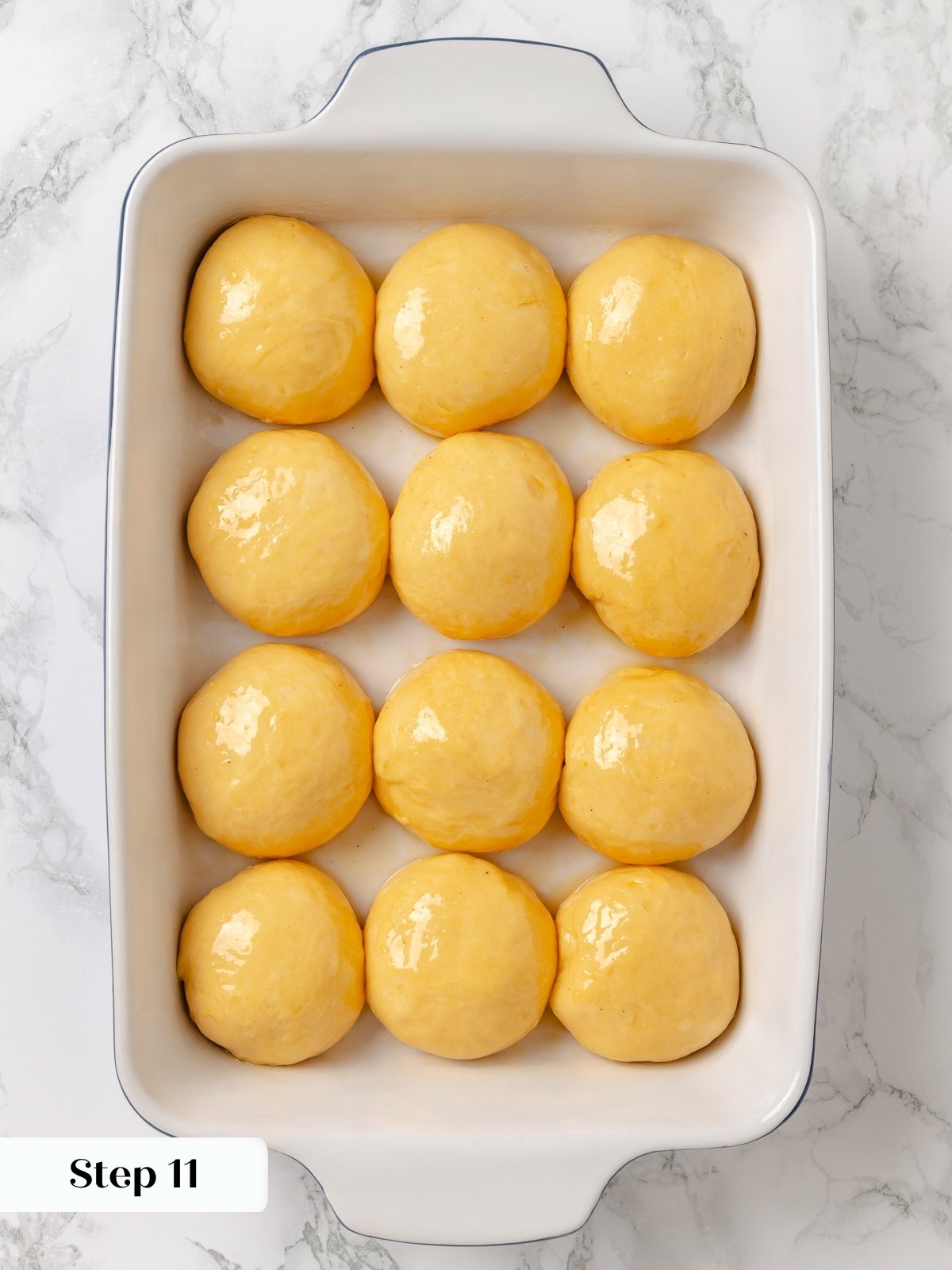 Unbaked sweet potato rolls arranged in a baking dish before going into the oven.