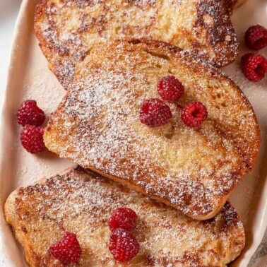 Thick slices of French toast with a soft, airy texture and golden brown color.