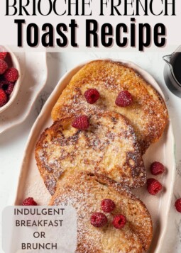 Plate of soft, golden brioche French toast sprinkled with powdered sugar.