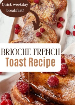 Thick slices of brioche French toast dusted with powdered sugar beside fresh raspberries and syrup.