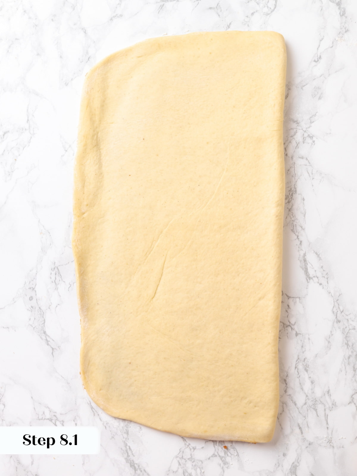 Rectangle of dough shaped to 12x8 inches, ready to be sliced into strips.