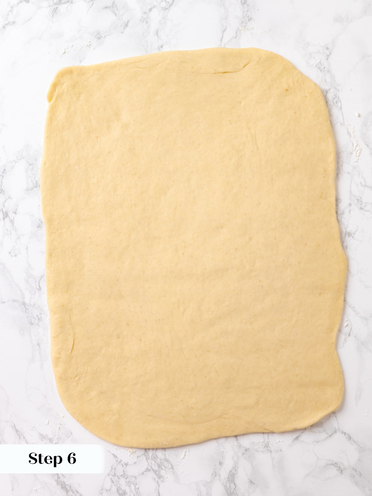 Dough rolled to 16x12 inches on a floured surface ready for filling and folding.