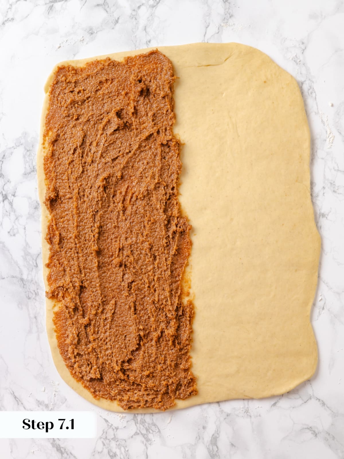 Butter, brown sugar, and cardamom filling spread across rolled dough before folding.