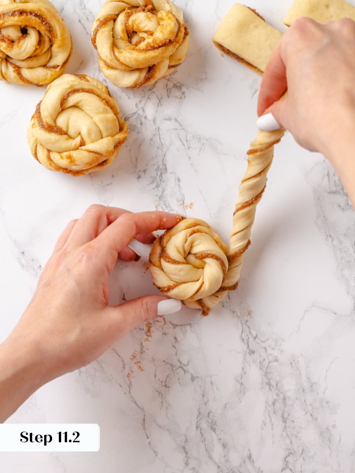 Twisting the left strand over and around to complete the cardamom bun&rsquo;s braided shape.