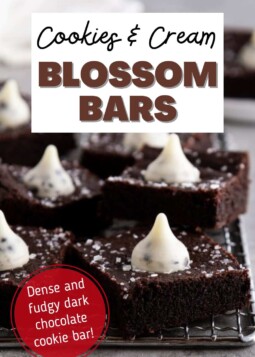 Dark chocolate cookie bars topped with sparkling sugar and a cookies and cream hershey's kiss.